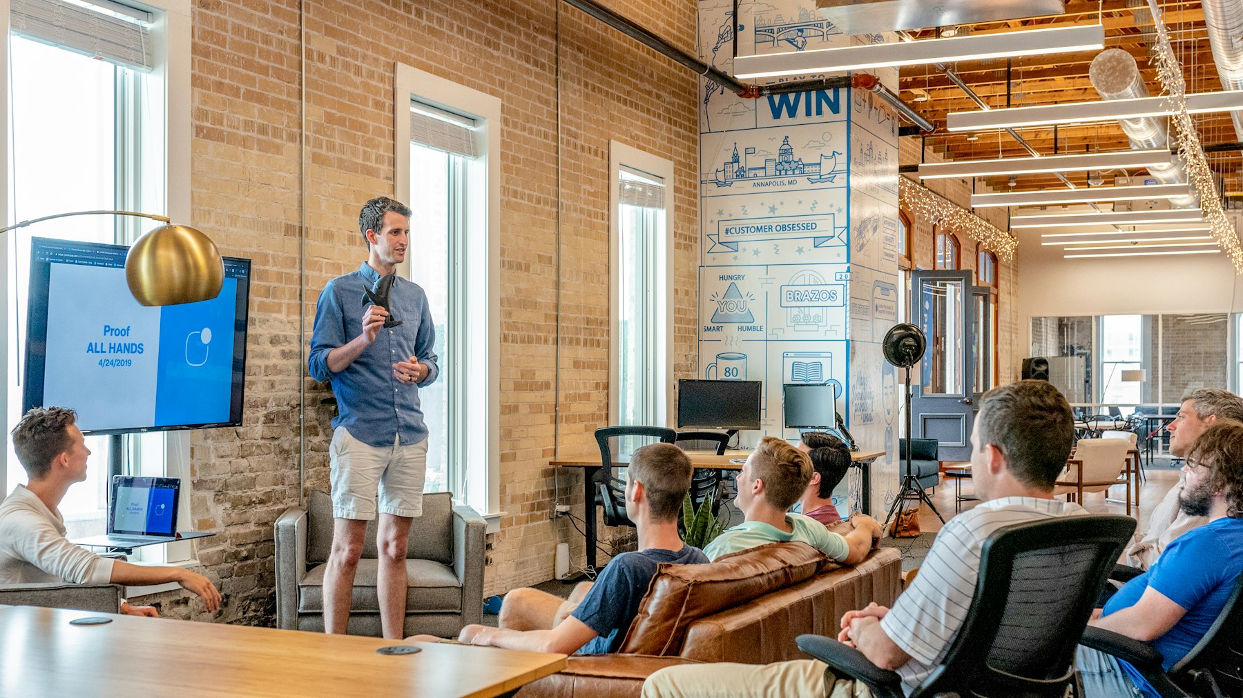A customer experience team discussing feedback in a bright meeting room