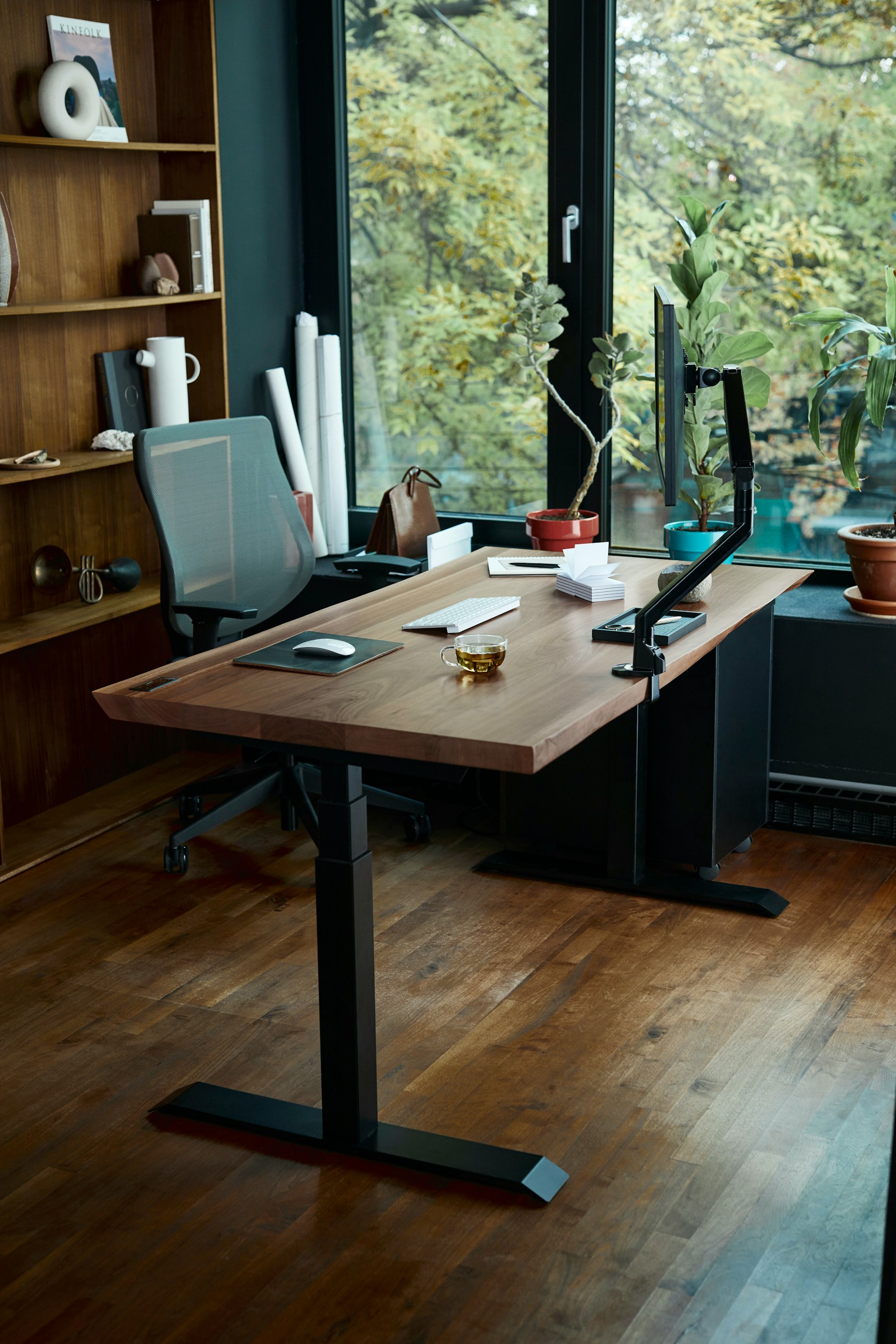 A calm modern office desk with a laptop near a window