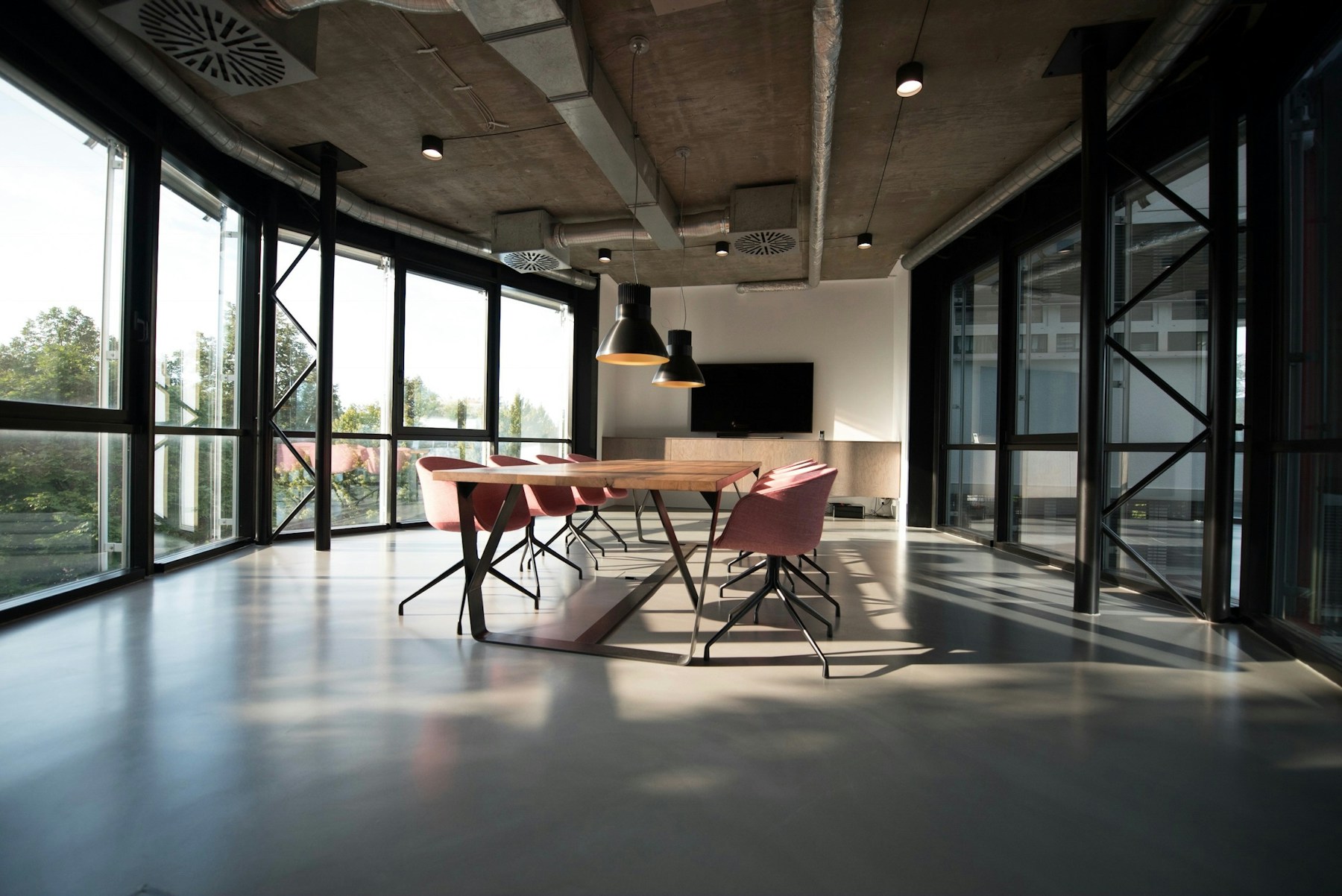 A spacious modern boardroom with chairs and daylight